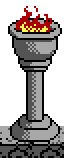 A tall stone torch with flames on top of it.